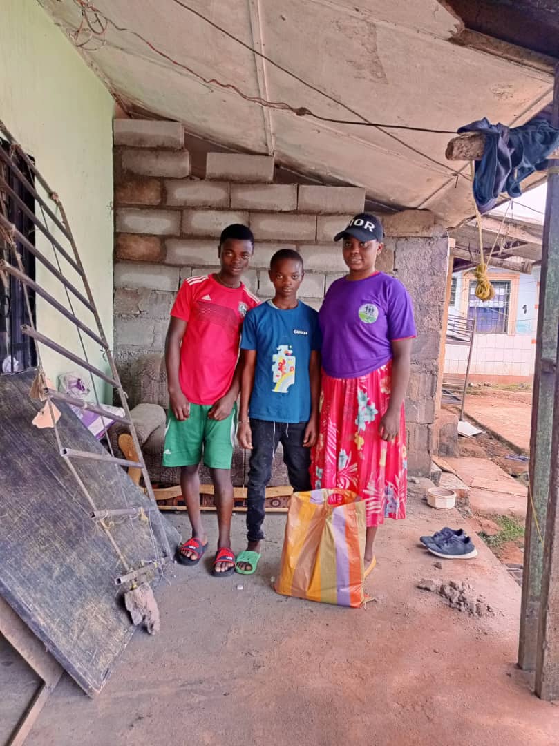 INADESU volunteers delivering food donations to a family in Buea